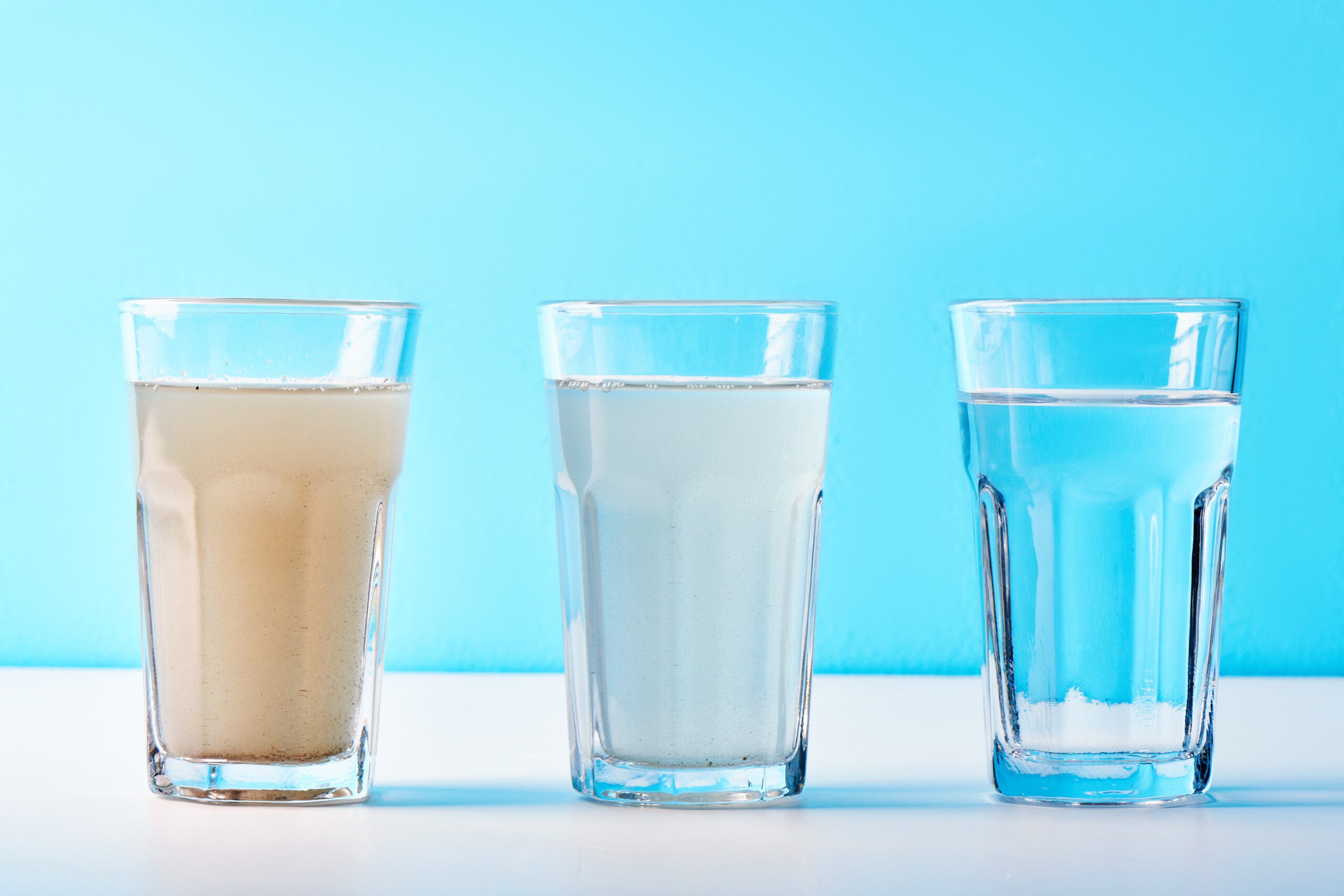 3 glasses with water from dirt to clean